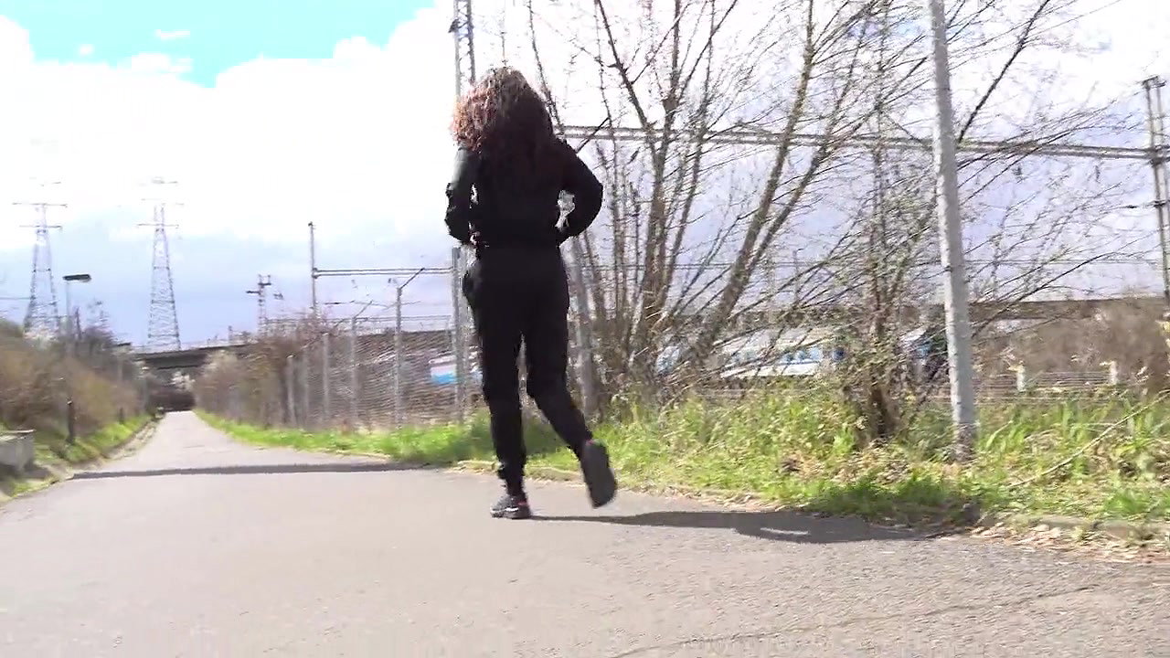 Ali B squats to pee next to the tramline