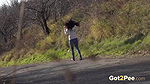 Ali Bordeaux pees on a road in the suburbs