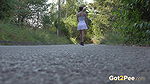 Ali Bordeaux stands and pees on a road