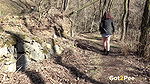 Amanda Hill squats to piss in the woodland