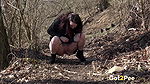 Amanda Hill squats to piss in the woodland
