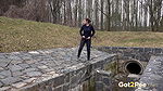 Antonia pees outside next to drainage pipe