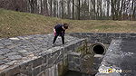 Antonia pees outside next to drainage pipe
