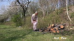 Blonde babe Claudia pees over some logs