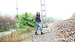 Ali B squats and pees near the train tracks