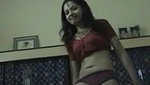 Young brunette in indian national dress strips for the camera