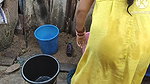 Indian house wife bathing outside