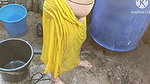 Indian house wife bathing outside