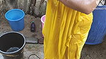 Indian house wife bathing outside