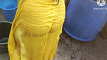 Indian house wife bathing outside