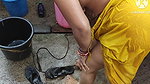 Indian house wife bathing outside