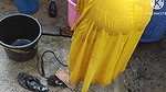 Indian house wife bathing outside