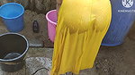 Indian house wife bathing outside