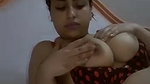 beautiful girl playing with her big round boobs