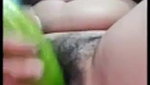 using a big cucumber to satisfy her needs