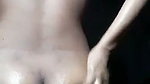 Beautiful girl applying oil on her nude body