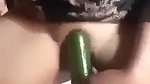 village girl inserting cucumber