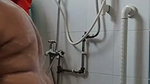 Mature lady bathing  wearing cloth