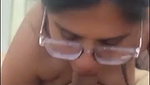 Glasses babe giving blowjob and using vibrator