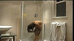 Sexy lady taking shower in hotel bathroom