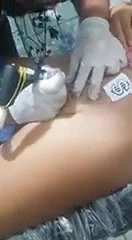 Cute chubby girl having tattoo on pussy