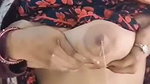 Hot housewife pressing her boobs  milk coming out