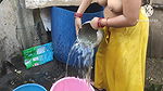 Indian woman bathing outside