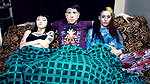 Punk dude with lots of tattoos is having a threesome with two skinny teens