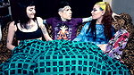 Punk dude with lots of tattoos is having a threesome with two skinny teens