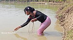 Bengali girl net fishing in Village pond