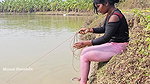 Bengali girl net fishing in Village pond