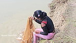 Bengali girl net fishing in Village pond