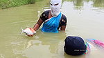Village Masked Women Fishing in Dangerous Water