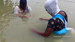 Village Masked Women Fishing in Dangerous Water