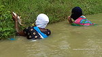 Village Masked Women Fishing in Dangerous Water