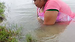 x Village women mud crab catching in the shore of Ba