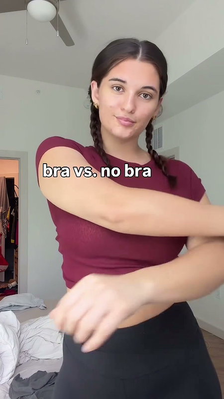 girl removing bra in red shirt 2 2