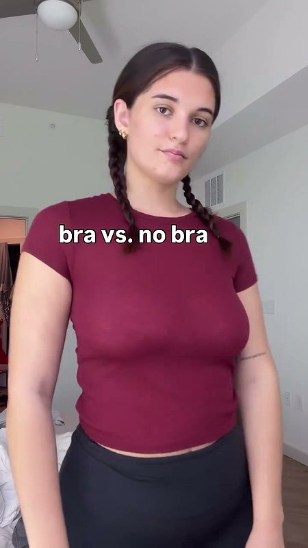 girl removing bra in red shirt 2 2
