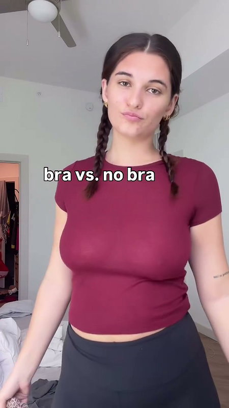 girl removing bra in red shirt 2 2