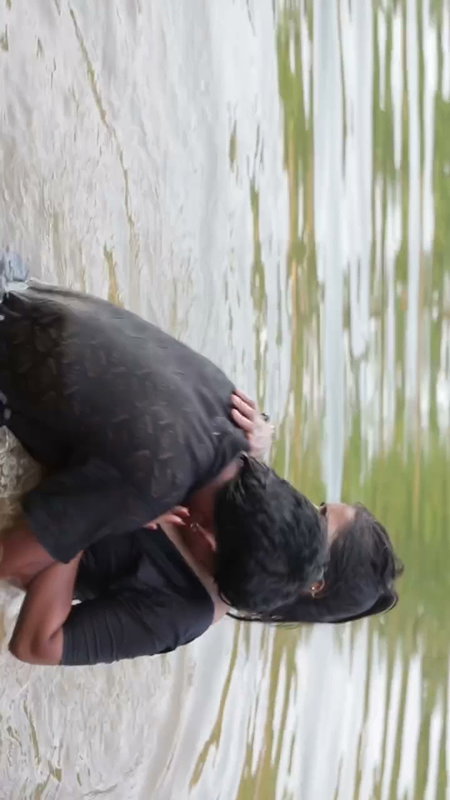 girl in wet blouse and skirt enjoyed in river