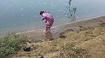 Indian village wife bathing in the river in outdoor area