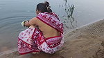 Indian village wife bathing in the river in outdoor area