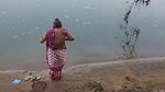 Indian village wife bathing in the river in outdoor area