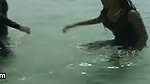 Swimming in the ocean with ebony babe