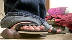 A girl in flip flops tramples a black dick