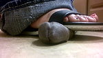 A girl in flip flops tramples a black dick