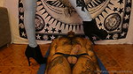 A girl presses her heels on a guy s balls and he likes it