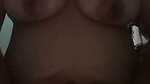 Squeezing the breasts after showering