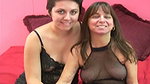 Mature dyke wearing fishnet lingerie gets strapon fucked by young brunette