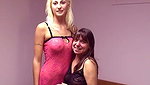 Platinum blonde spreads her legs so brunette can shove dildo up her cunt